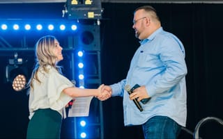 Director of Sales Justine Songey shakes hands with a customer while presenting at Verkada’s global sales kickoff.