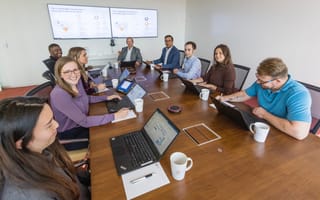 ZS team members around conference table in meeting